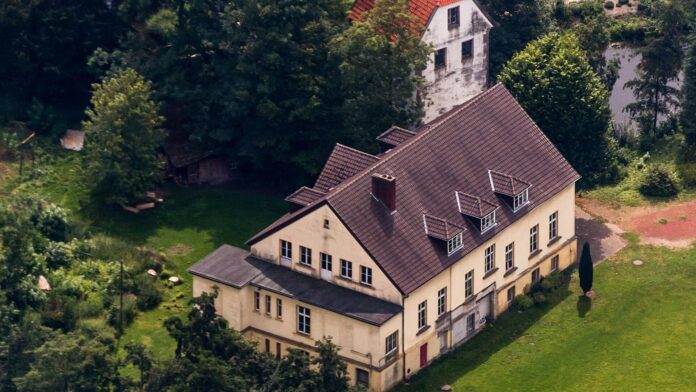 Luftaufnahme der Kulturinsel Bispinghof in Nordwalde: Herrenhaus mit Speicher, umgeben von Bäumen und Wiese